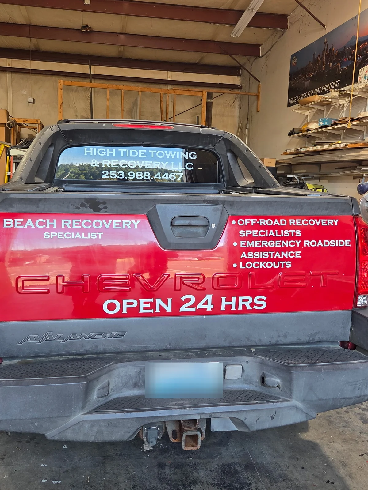 Red High Tide recovery truck marked for 24-hour service